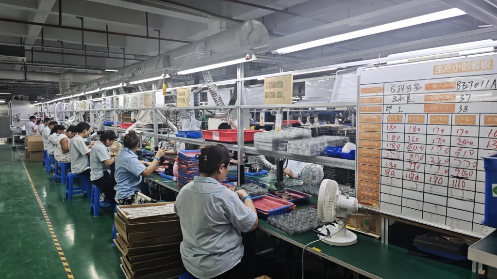 Audio product assembly production line with workers assembling headphones in BETRUE's manufacturing facility.