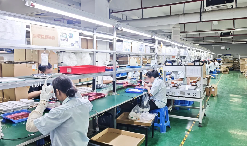 BeTrue Technology headphone quality inspection workstation with operators performing final product checks